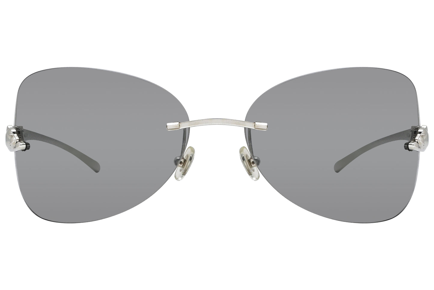 A pair of rimless sunglasses with a silver frame and grey lenses.