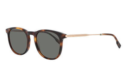 Sunglasses with tortoiseshell frame and dark lenses on a white background