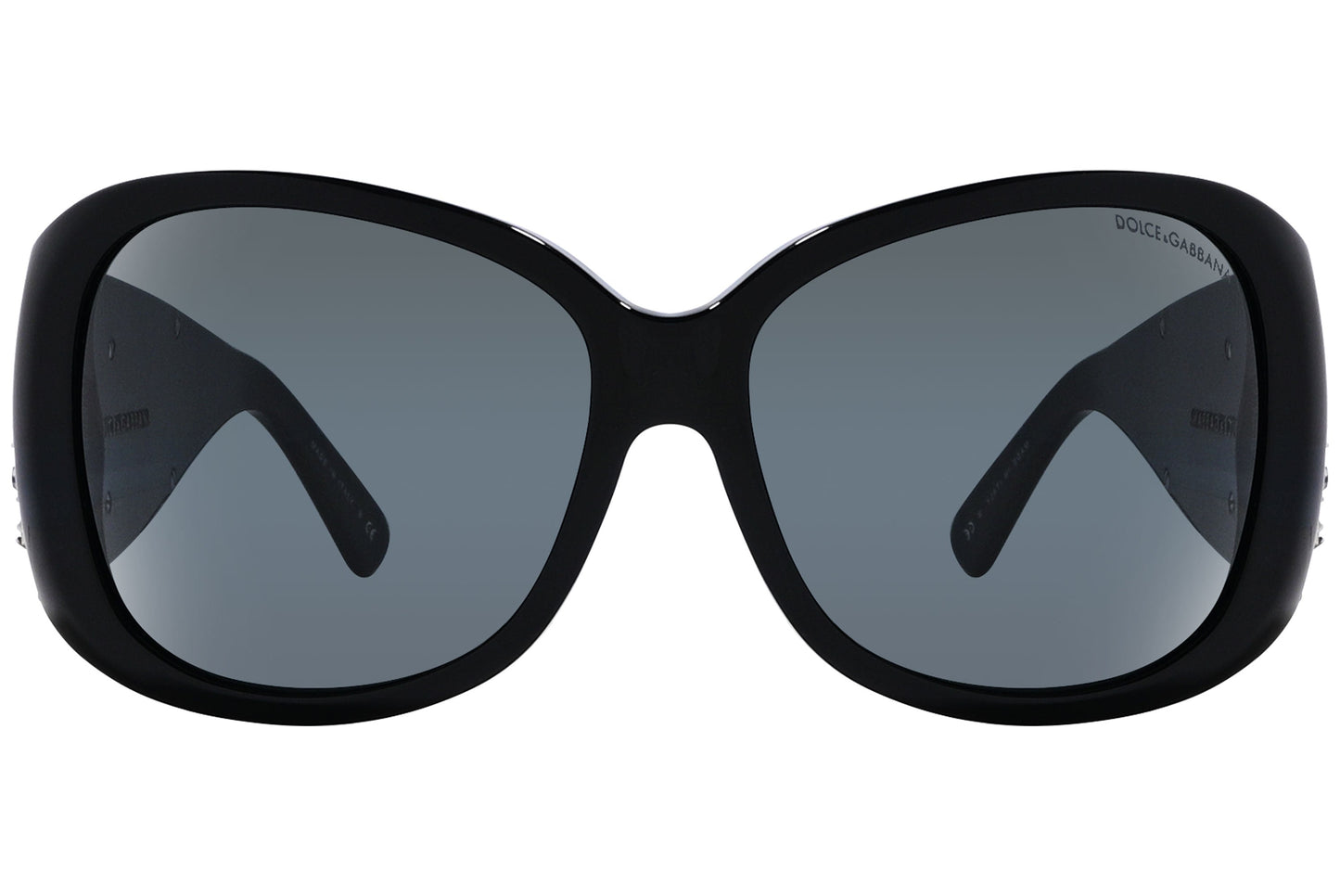 Close-up of Dolce & Gabbana oval sunglasses in green highlighting frame texture and logo detail

