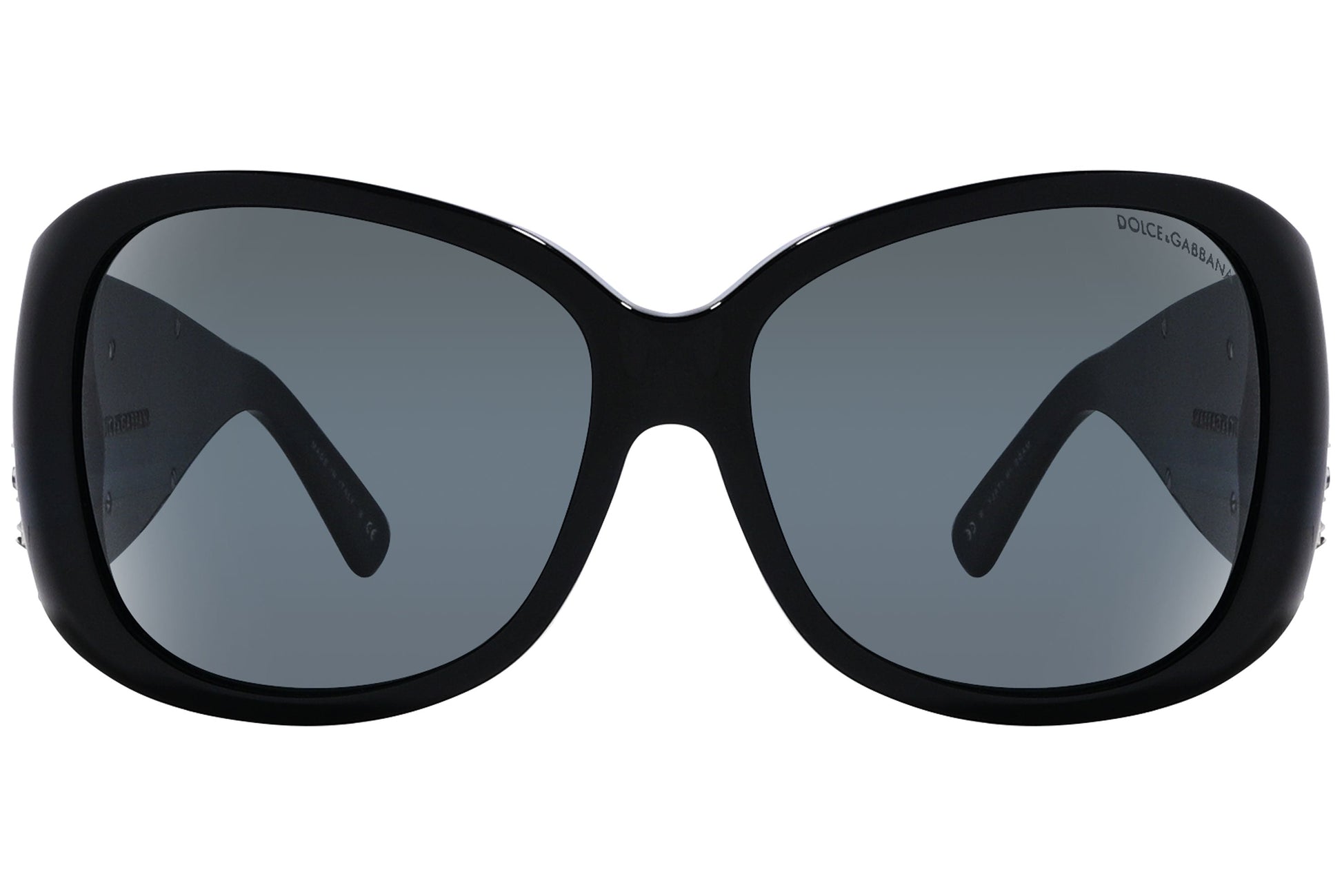 Close-up of Dolce & Gabbana oval sunglasses in green highlighting frame texture and logo detail

