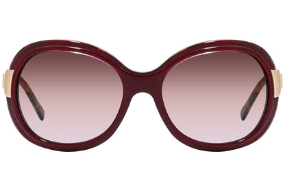 Close-up of Dolce & Gabbana red oval sunglasses with glossy finish and lens detailing